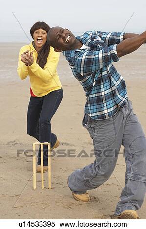 Young Couple Playing Cricket On Autumn Beach Holiday View Large Photo Image Stock Photography - Young Couple Playing Cricket On Autumn Beach Holiday. Fotosearch
