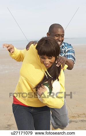 Young Couple Playing Rugby On Autumn Beach Holiday View Large Photo Image Stock Photo - Young Couple Playing Rugby On Autumn Beach Holiday. Fotosearch