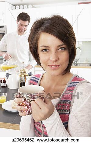 Young Couple Preparing Breakfast In Modern Kitchen View Large Photo Image Stock Image - Young Couple Preparing Breakfast In Modern Kitchen . Fotosearch