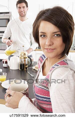 Young Couple Preparing Breakfast In Modern Kitchen View Large Photo Image Stock Photo - Young Couple Preparing Breakfast In Modern Kitchen . Fotosearch