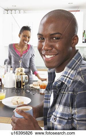 Young Couple Preparing Breakfast In Modern Kitchen View Large Photo Image Stock Photograph - Young Couple Preparing Breakfast In Modern Kitchen . Fotosearch