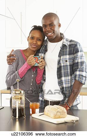 Young Couple Preparing Breakfast In Modern Kitchen View Large Photo Image Stock Photograph - Young Couple Preparing Breakfast In Modern Kitchen . Fotosearch