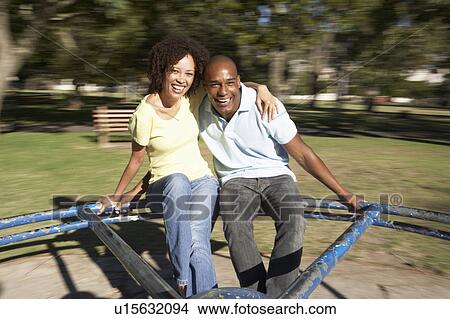 Young Couple Riding On Roundabout In Park View Large Photo Image Picture - Young Couple Riding On Roundabout In Park. Fotosearch