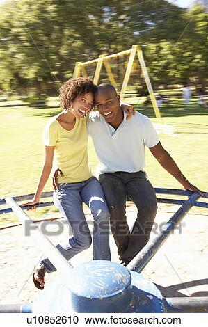 Young Couple Riding On Roundabout In Park View Large Photo Image Stock Image - Young Couple Riding On Roundabout In Park. Fotosearch