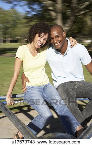 Young Couple Riding On Roundabout In Park View Large Photo Image Stock Image - Young Couple Riding On Roundabout In Park. Fotosearch