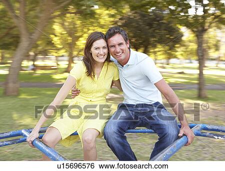 Young Couple Riding On Roundabout In Park View Large Photo Image Stock Photograph - Young Couple Riding On Roundabout In Park. Fotosearch