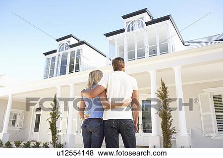 Young Couple Standing Outside Dream Home View Large Photo Image Stock Photo - Young Couple Standing Outside Dream Home. Fotosearch