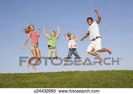 Young couple with children jump in a field View Large Photo Image Stock Photography - Young couple with children jump in a field. Fotosearch