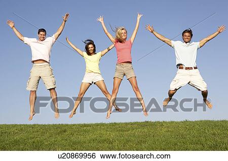 Young couples jumping in air View Large Photo Image Stock Photograph - Young couples jumping in air. Fotosearch
