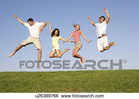 Young couples jumping in air View Large Photo Image Stock Photograph - Young couples jumping in air. Fotosearch