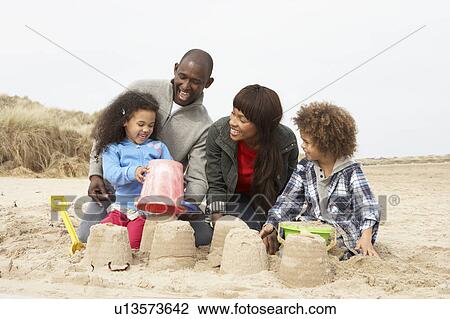 Young Family Building Sandcastle On Beach Holiday View Large Photo Image Stock Image - Young Family Building Sandcastle On Beach Holiday. Fotosearch
