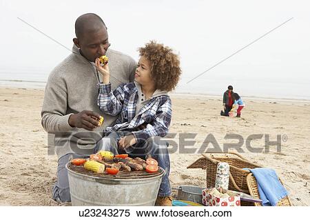 Young Family Enjoying Barbeque On Beach View Large Photo Image Stock Photography - Young Family Enjoying Barbeque On Beach. Fotosearch