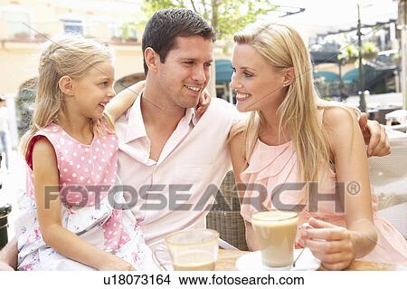 Young Family Enjoying Cup Of Coffee In Café Together View Large Photo Image Picture - Young Family Enjoying Cup Of Coffee In Café Together. Fotosearch