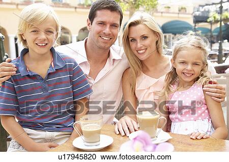 Young Family Enjoying Cup Of Coffee In Café Together View Large Photo Image Stock Image - Young Family Enjoying Cup Of Coffee In Café Together. Fotosearch
