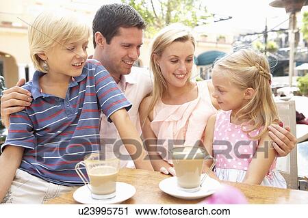 Young Family Enjoying Cup Of Coffee In Café Together View Large Photo Image Stock Image - Young Family Enjoying Cup Of Coffee In Café Together. Fotosearch