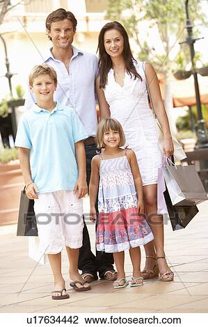 Stock Image - Young Family Enjoying Shopping Trip Together. Fotosearch