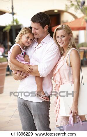 Young Family Enjoying Shopping Trip Together View Large Photo Image Stock Photo - Young Family Enjoying Shopping Trip Together. Fotosearch