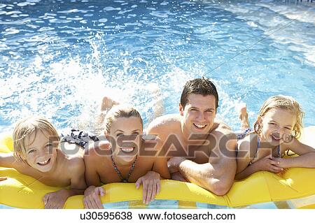 Young family having fun together in pool View Large Photo Image Stock Photo - Young family having fun together in pool. Fotosearch