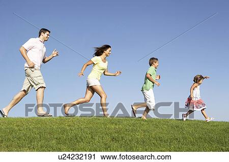 Young family, parents with children, running through field View Large Photo Image Stock Image - Young family, parents with children, running through field. Fotosearch