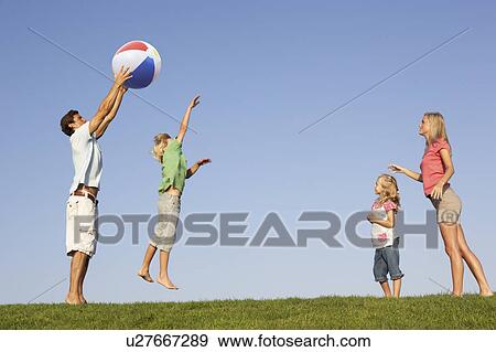 Young family, parents with children, playing in a field View Large Photo Image Stock Photo - Young family, parents with children, playing in a field. Fotosearch