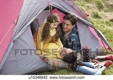 Young Family Relaxing Inside Tent On Camping Holiday View Large Photo Image Stock Image - Young Family Relaxing Inside Tent On Camping Holiday. Fotosearch