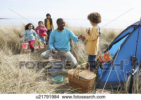 Picture - Young Family Relaxing On Beach Camping Holiday. Fotosearch