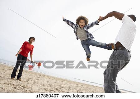 Young Family Relaxing On Beach Camping Holiday View Large Photo Image Stock Photo - Young Family Relaxing On Beach Camping Holiday. Fotosearch
