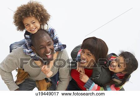 Stock Photo - Young Family Relaxing On Beach Camping Holiday. Fotosearch