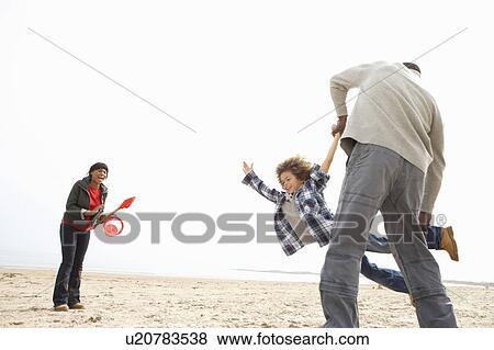 Young Family Relaxing On Beach Camping Holiday View Large Photo Image Stock Photo - Young Family Relaxing On Beach Camping Holiday. Fotosearch