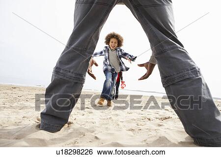 Stock Photograph - Young Family Relaxing On Beach Camping Holiday. Fotosearch