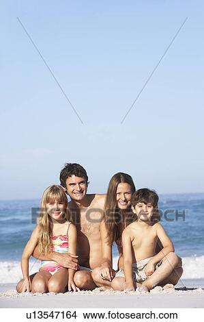 Young Family Relaxing On Beach Holiday View Large Photo Image Picture - Young Family Relaxing On Beach Holiday. Fotosearch