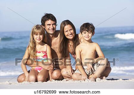Young Family Relaxing On Beach Holiday View Large Photo Image Stock Photo - Young Family Relaxing On Beach Holiday. Fotosearch