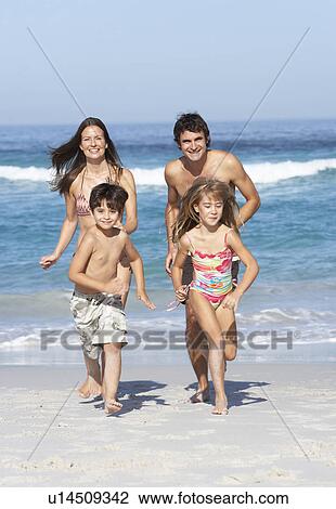 Young Family Running Along Beach on Holiday View Large Photo Image Stock Image - Young Family Running Along Beach on Holiday. Fotosearch