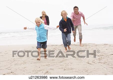 Young Family Running Along Winter Beach View Large Photo Image Stock Photograph - Young Family Running Along Winter Beach. Fotosearch