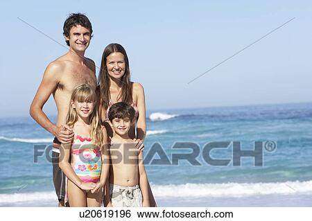 Young Family Standing On Sandy Beach on Holiday View Large Photo Image Stock Photograph - Young Family Standing On Sandy Beach on Holiday. Fotosearch