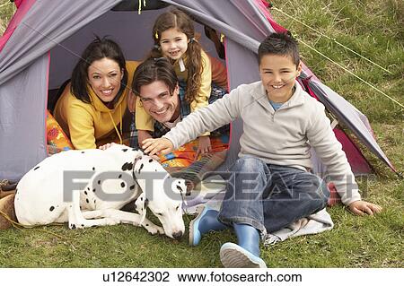 Young Family With Dog Relaxing Inside Tent On Camping Holiday View Large Photo Image Stock Image - Young Family With Dog Relaxing Inside Tent On Camping Holiday. Fotosearch