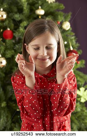 Young Girl Crossing Fingers In Front Of Christmas Tree View Large Photo Image Stock Image - Young Girl Crossing Fingers In Front Of Christmas Tree. Fotosearch
