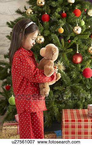Young Girl Cuddling Teddy Bear In Front Of Christmas Tree View Large Photo Image Stock Photo - Young Girl Cuddling Teddy Bear In Front Of Christmas Tree. Fotosearch