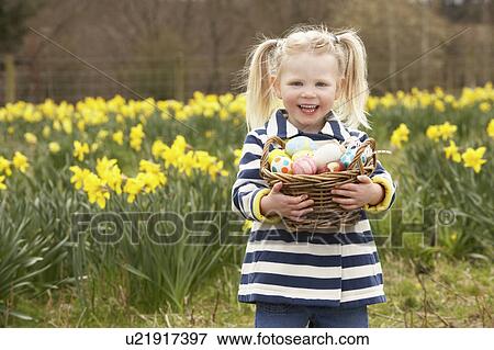 Young Girl Holding Basket Of Decorated Eggs In Daffodil Field View Large Photo Image Stock Photo - Young Girl Holding Basket Of Decorated Eggs In Daffodil Field. Fotosearch