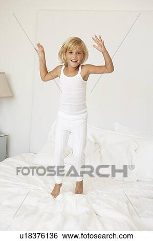 Young Girl Jumping On Bed View Large Photo Image Stock Photograph - Young Girl Jumping On Bed. Fotosearch