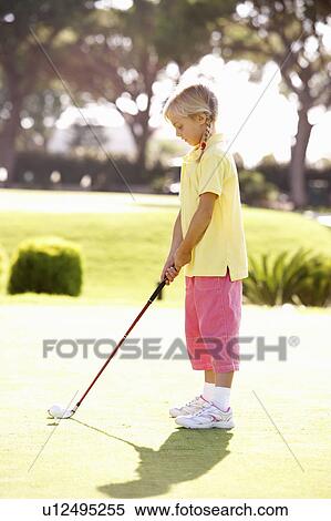 Stock Photography - Young Girl Practising Golf On Putting On Green. Fotosearch