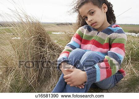 Young Girl Sitting Amongst Dunes On Winter Beach View Large Photo Image Stock Image - Young Girl Sitting Amongst Dunes On Winter Beach. Fotosearch