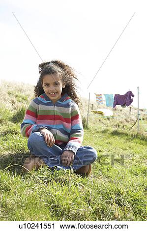 Stock Image - Young Girl Sitting Outside In Caravan Park. Fotosearch