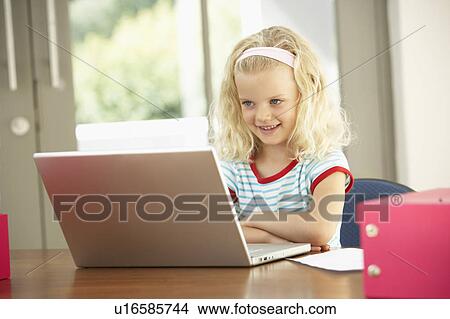 Picture - Young Girl Using Laptop At Home. Fotosearch