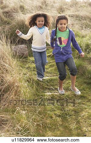 Young Girls Playing In Field Together View Large Photo Image Picture - Young Girls Playing In Field Together. Fotosearch