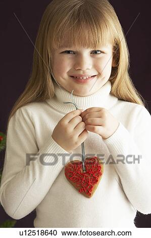 Young Holding Heart Shaped Cookie In Studio View Large Photo Image Stock Image - Young Holding Heart Shaped Cookie In Studio. Fotosearch