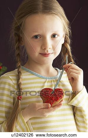 Young Holding Heart Shaped Cookie In Studio View Large Photo Image Stock Photograph - Young Holding Heart Shaped Cookie In Studio. Fotosearch