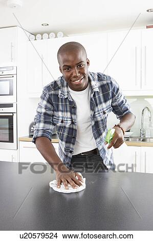 Picture - Young Man Cleaning Modern Kitchen . Fotosearch