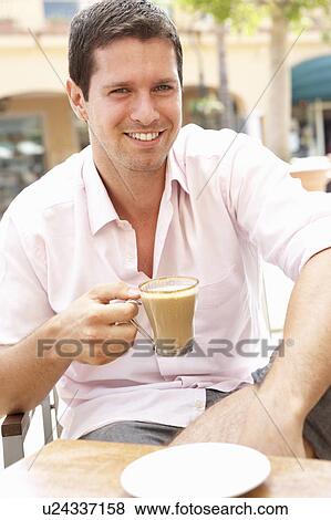 Young Man Enjoying Cup Of Coffee In Café View Large Photo Image Stock Photo - Young Man Enjoying Cup Of Coffee In Café. Fotosearch