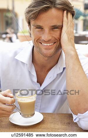Young Man Enjoying Cup Of Coffee In Café View Large Photo Image Stock Photography - Young Man Enjoying Cup Of Coffee In Café. Fotosearch